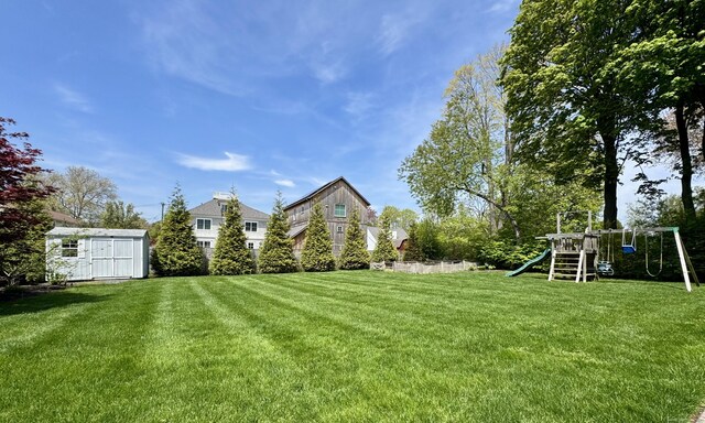 27 Dock Rd, Milford, CT 06460 - view of yard featuring a playground, a storage unit, and an outdoor structure