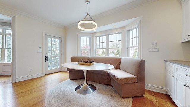 27 Dock Rd, Milford, CT 06460 - dining space with baseboards, ornamental molding, and light wood-style flooring