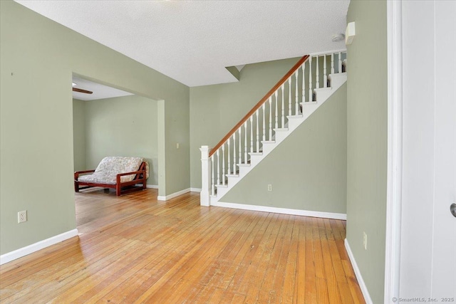 interior space featuring stairway, baseboards, and wood-type flooring