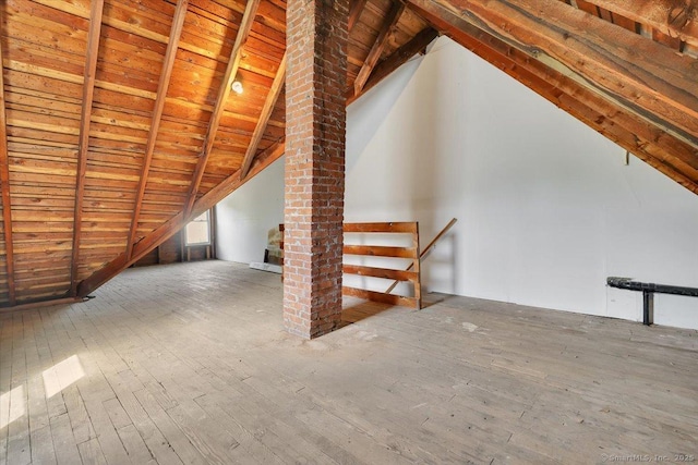 unfinished attic featuring an upstairs landing