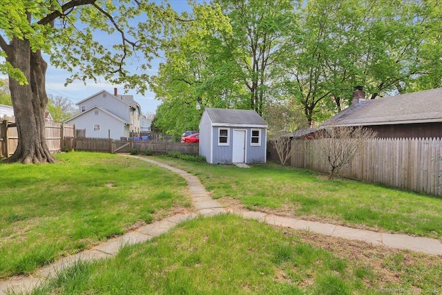 view of yard featuring an outdoor structure, a storage shed, and a fenced backyard