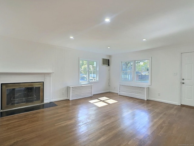 141 Arcadia Ave, Bridgeport, CT 06604 - unfurnished living room with radiator, baseboards, recessed lighting, and wood finished floors