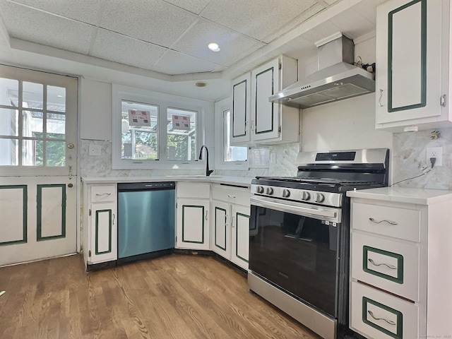 141 Arcadia Ave, Bridgeport, CT 06604 - kitchen featuring wall chimney range hood, stainless steel gas range, light countertops, a sink, and dishwasher