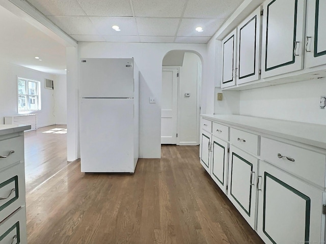 141 Arcadia Ave, Bridgeport, CT 06604 - kitchen featuring freestanding refrigerator, dark wood-style flooring, recessed lighting, light countertops, and arched walkways