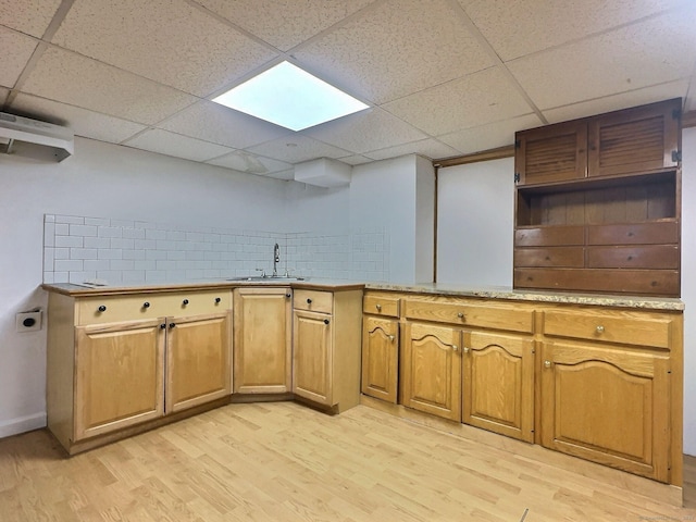 141 Arcadia Ave, Bridgeport, CT 06604 - kitchen featuring light countertops, a drop ceiling, a sink, and light wood-type flooring
