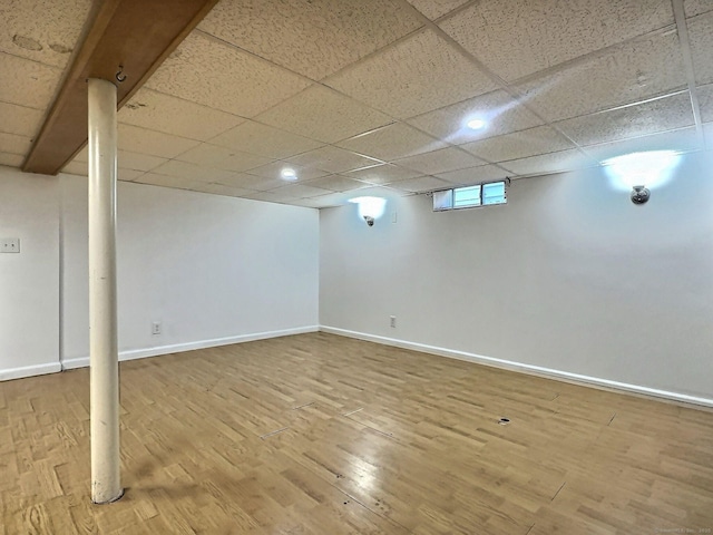 141 Arcadia Ave, Bridgeport, CT 06604 - below grade area featuring a paneled ceiling, baseboards, and wood finished floors