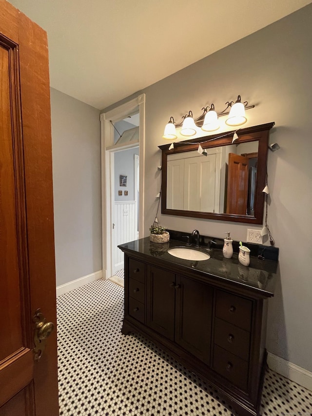 bathroom featuring baseboards and vanity