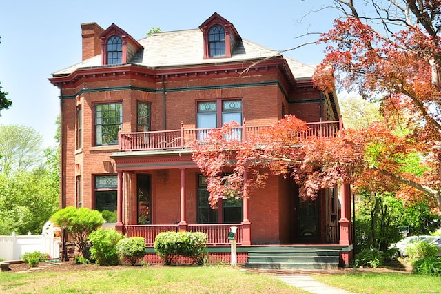 1123 Windsor Ave, Windsor, CT 06095 - view of front of property featuring a balcony, brick siding, covered porch, and a chimney