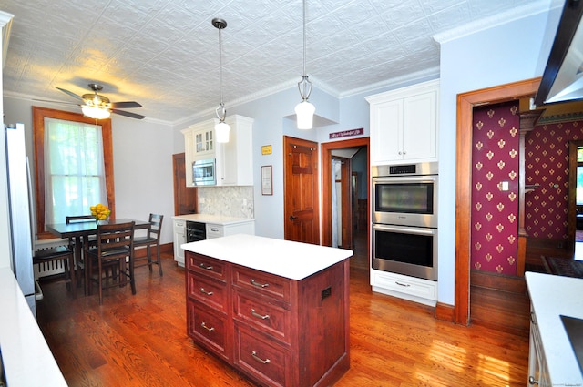 1123 Windsor Ave, Windsor, CT 06095 - kitchen with stainless steel appliances, dark wood-type flooring, light countertops, ceiling fan, and baseboards