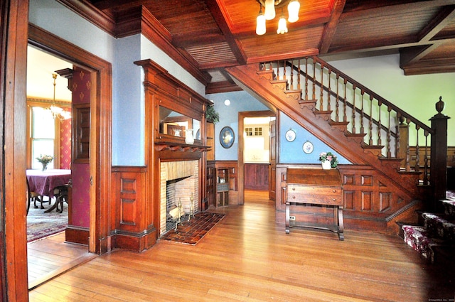 1123 Windsor Ave, Windsor, CT 06095 - living room featuring wooden ceiling, stairs, a wainscoted wall, beam ceiling, and a chandelier