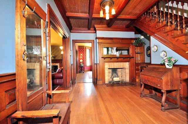 1123 Windsor Ave, Windsor, CT 06095 - living area featuring a brick fireplace, wood finished floors, wooden ceiling, beamed ceiling, and crown molding