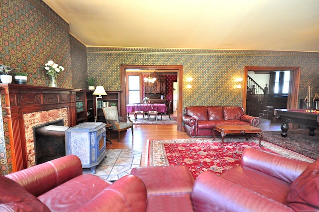 1123 Windsor Ave, Windsor, CT 06095 - living area featuring wallpapered walls, stairs, wood finished floors, ornamental molding, and a fireplace