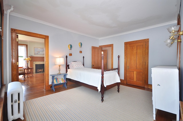 1123 Windsor Ave, Windsor, CT 06095 - bedroom with wood finished floors, ornamental molding, a fireplace, and radiator