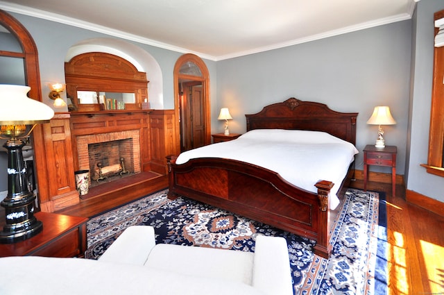 1123 Windsor Ave, Windsor, CT 06095 - bedroom with wood finished floors, a brick fireplace, and crown molding