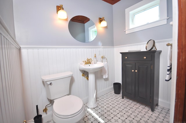 1123 Windsor Ave, Windsor, CT 06095 - bathroom with wainscoting, toilet, tile patterned floors, and baseboards