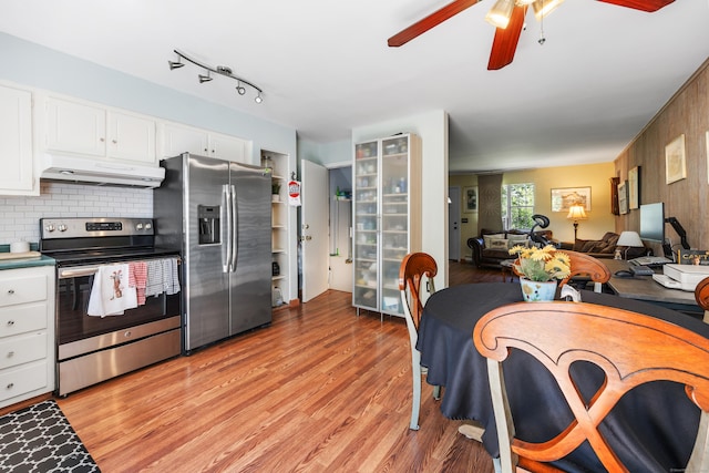 kitchen featuring under cabinet range hood, ceiling fan, stainless steel appliances, white cabinets, and light wood-type flooring
