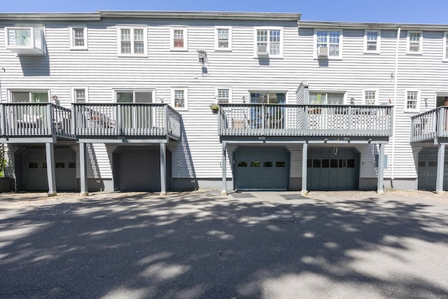 rear view of property with an attached garage