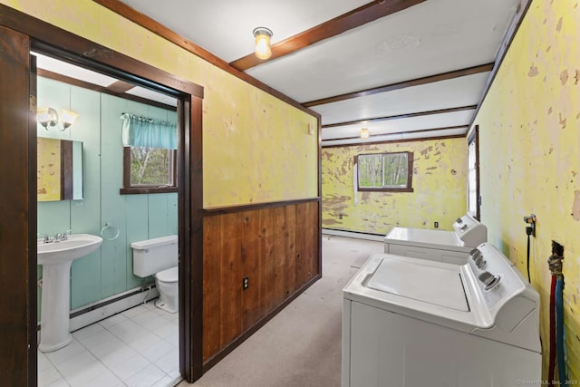 washroom featuring baseboard heating, washing machine and dryer, wallpapered walls, and laundry area