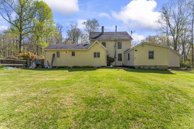 back of property featuring a yard