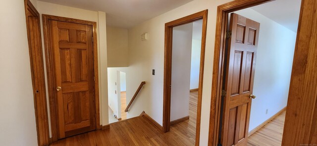 116 Aimes Dr, West Haven, CT 06516 - corridor featuring light wood-style floors, baseboards, and an upstairs landing