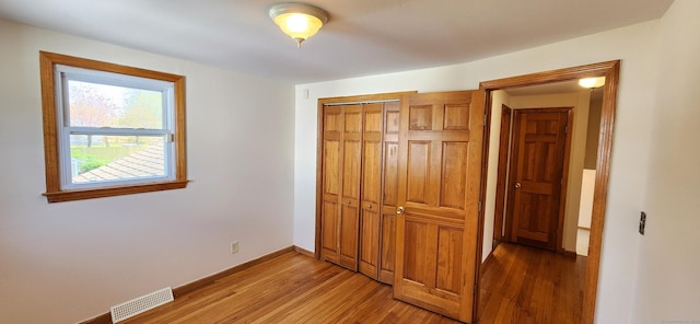 116 Aimes Dr, West Haven, CT 06516 - unfurnished bedroom featuring light wood-style floors, baseboards, a closet, and visible vents