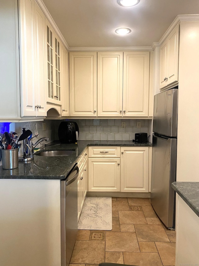 62 Wood Ridge Dr, Stamford, CT 06905 - kitchen with decorative backsplash, appliances with stainless steel finishes, a sink, glass insert cabinets, and dark stone counters