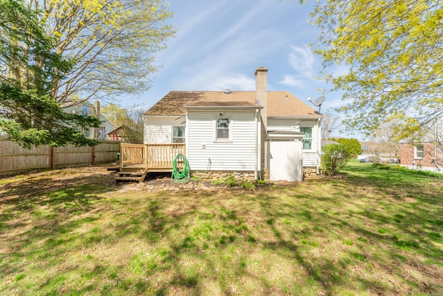 23 Strosberg Rd, Waterford, CT 06385 - back of property featuring fence, a chimney, a lawn, and a deck