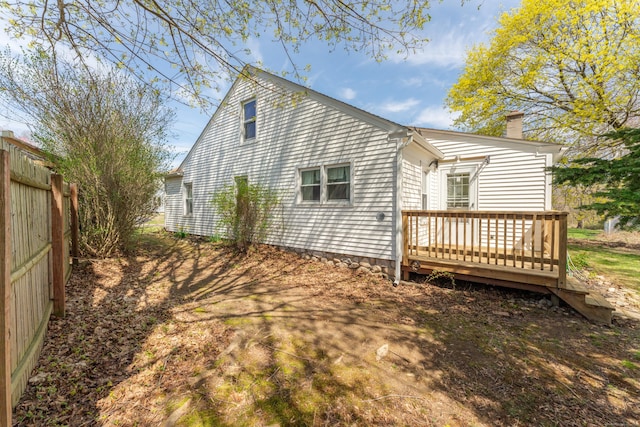 23 Strosberg Rd, Waterford, CT 06385 - back of house featuring fence, a wooden deck, and a chimney