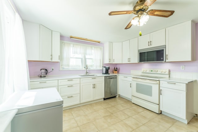 23 Strosberg Rd, Waterford, CT 06385 - kitchen with light countertops, white cabinets, appliances with stainless steel finishes, and a sink