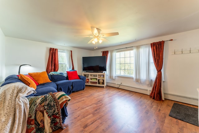 23 Strosberg Rd, Waterford, CT 06385 - living area with baseboards, ceiling fan, baseboard heating, and wood finished floors