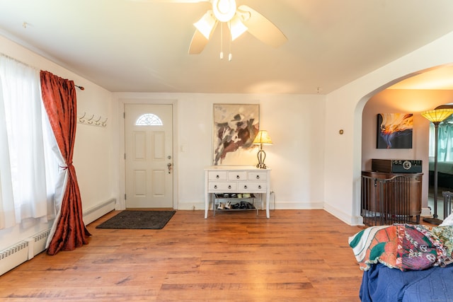 23 Strosberg Rd, Waterford, CT 06385 - foyer entrance featuring arched walkways, a ceiling fan, a baseboard heating unit, and a wealth of natural light