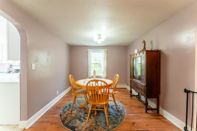 23 Strosberg Rd, Waterford, CT 06385 - dining space with baseboards, arched walkways, and light wood-style flooring