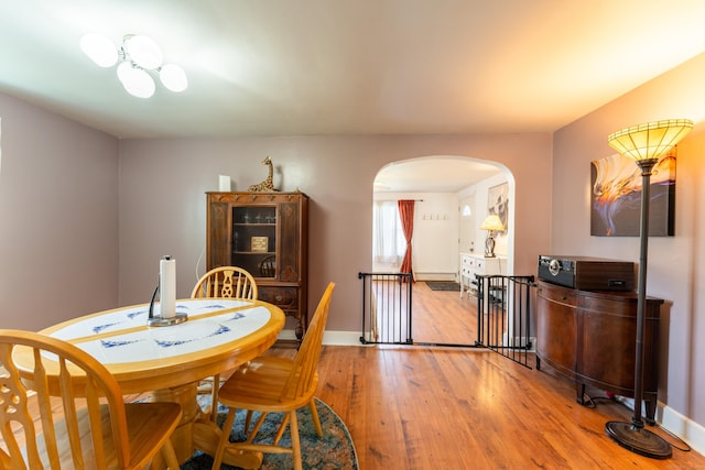 23 Strosberg Rd, Waterford, CT 06385 - dining space featuring arched walkways, baseboards, and hardwood / wood-style floors
