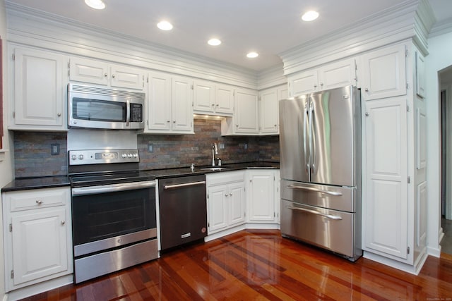 22 Maple Ln Unit 22, Avon, CT 06001 - kitchen with appliances with stainless steel finishes, dark countertops, a sink, dark wood-type flooring, and white cabinets