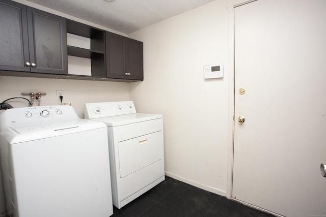 22 Maple Ln Unit 22, Avon, CT 06001 - laundry area with washing machine and clothes dryer, cabinet space, baseboards, and a textured ceiling