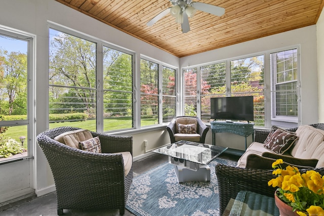 sunroom featuring a healthy amount of sunlight, a ceiling fan, and an outdoor hangout area