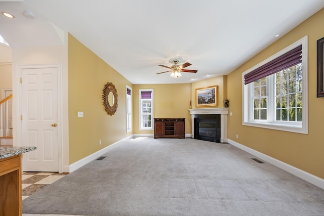 85 Chippenwood Ln, Bristol, CT 06010 - unfurnished living room with baseboards, a glass covered fireplace, and plenty of natural light