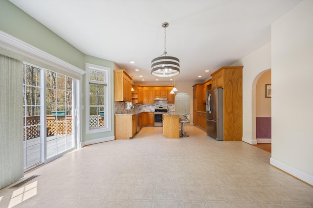 85 Chippenwood Ln, Bristol, CT 06010 - kitchen featuring visible vents, baseboards, arched walkways, appliances with stainless steel finishes, and a notable chandelier