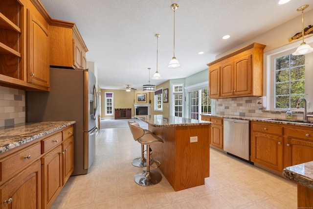 85 Chippenwood Ln, Bristol, CT 06010 - kitchen featuring a sink, light floors, open floor plan, and stainless steel appliances