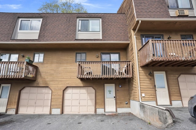 895 Matthews St Apt 46, Bristol, CT 06010 - view of property featuring driveway, cooling unit, and a garage