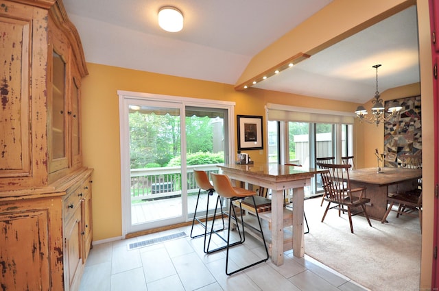 dining room with lofted ceiling, a chandelier, baseboards, and light tile patterned floors