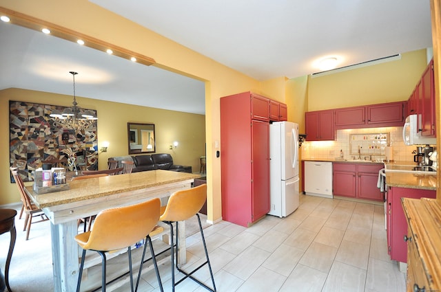 kitchen featuring white appliances, a chandelier, decorative backsplash, light countertops, and recessed lighting