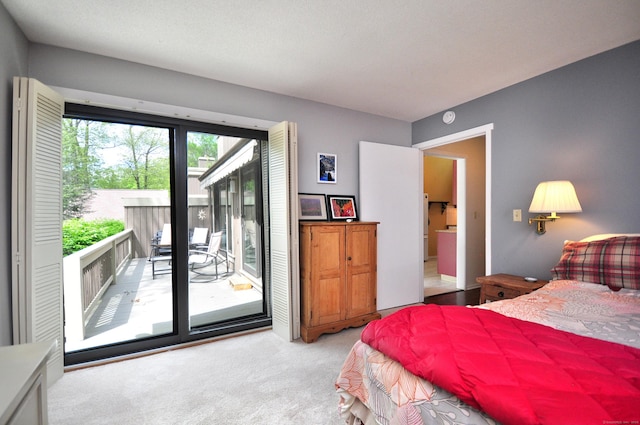 carpeted bedroom with access to outside