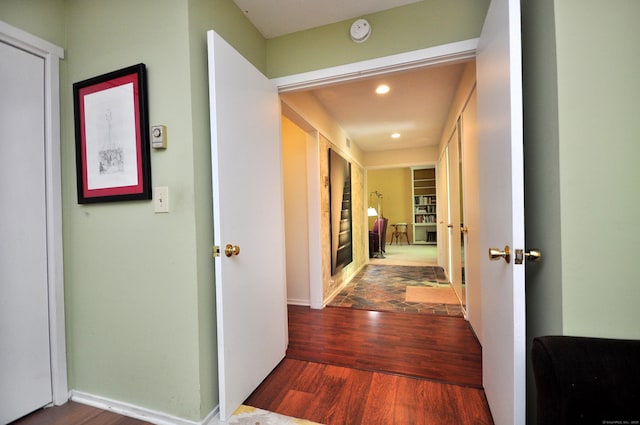 hall featuring wood finished floors, recessed lighting, and baseboards