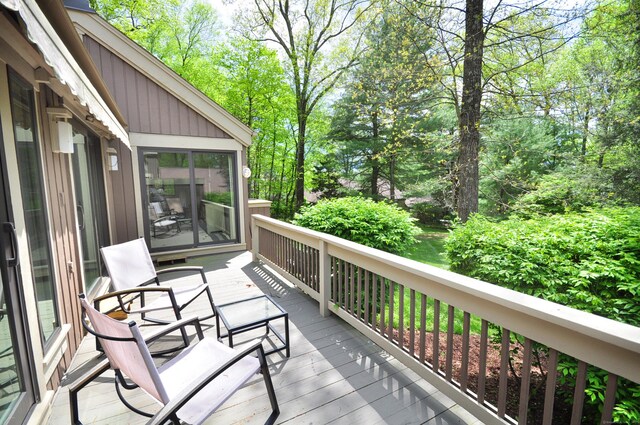 wooden terrace featuring view of scattered trees