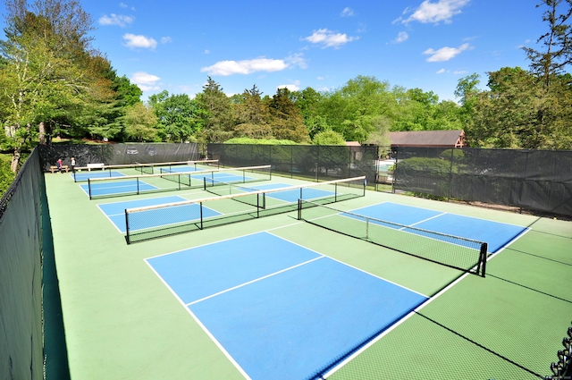 view of tennis court with fence and community basketball court