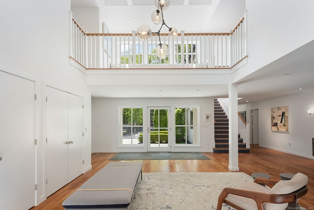 1580 Ponus Rdg, New Canaan, CT 06840 - entrance foyer with a towering ceiling, stairway, light wood-style flooring, a chandelier, and baseboards