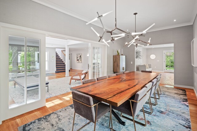 1580 Ponus Rdg, New Canaan, CT 06840 - dining room featuring light wood-style flooring, stairs, ornamental molding, baseboards, and a chandelier