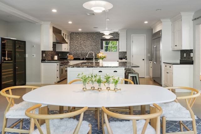 1580 Ponus Rdg, New Canaan, CT 06840 - kitchen with premium appliances, tasteful backsplash, a sink, wall chimney exhaust hood, and an island with sink