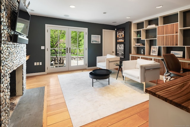 1580 Ponus Rdg, New Canaan, CT 06840 - sitting room with wood finished floors, french doors, baseboards, recessed lighting, and a fireplace with flush hearth